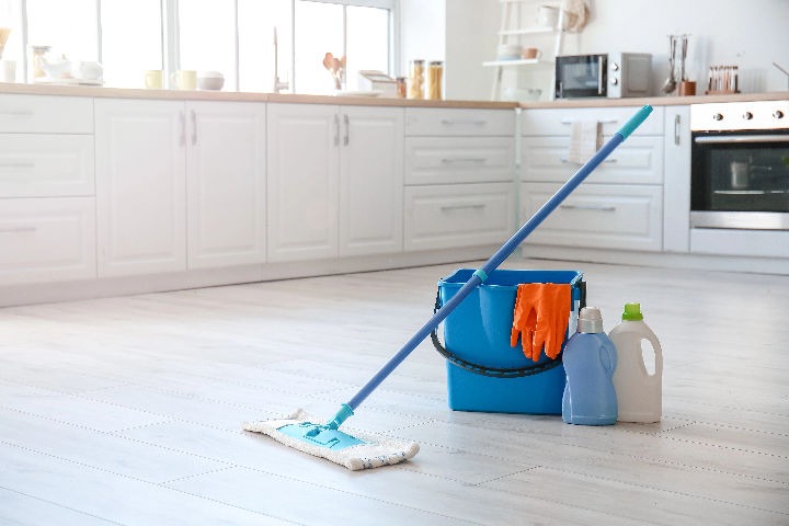 Cleaning products on a kitchen floor.